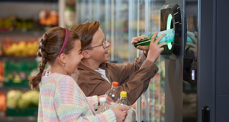 Children using reverse vending machine