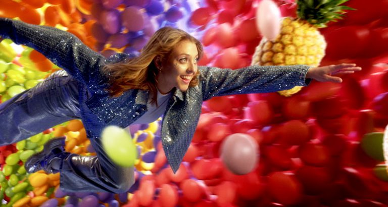 Girl flying through a cloud of sweets