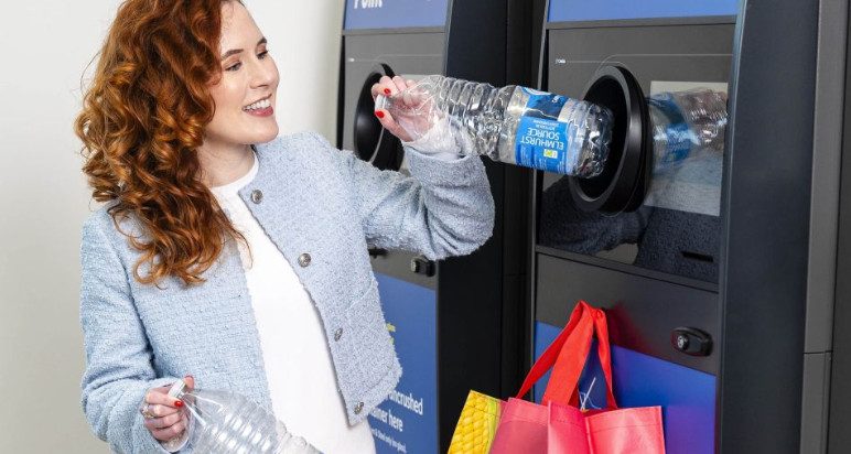 An image of a lady using a reverse vending machine