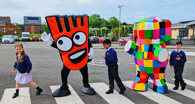 Patchwork elephant on a zebra crossing