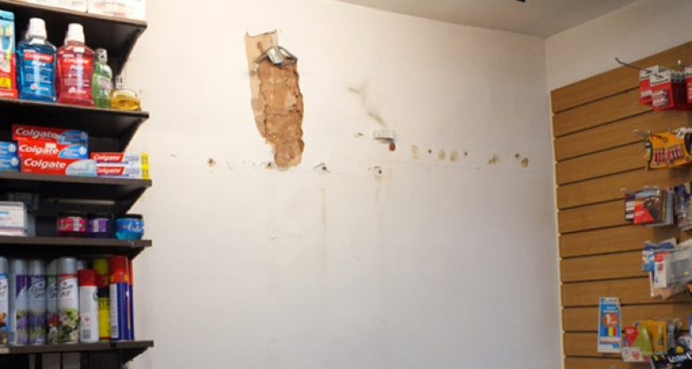 Shop's internal wall showing clear signs of a fixture removal