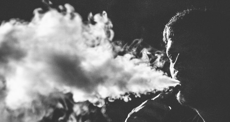 Black and white photo of man vaping